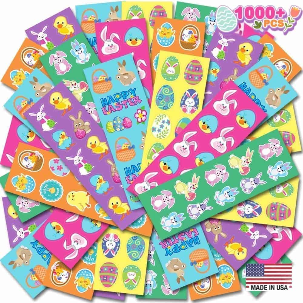 A variety of colorful Easter-themed stickers featuring eggs, bunnies, chicks, and baskets, arranged in a fan shape. Text indicates over 1000 pieces and "Made in USA.