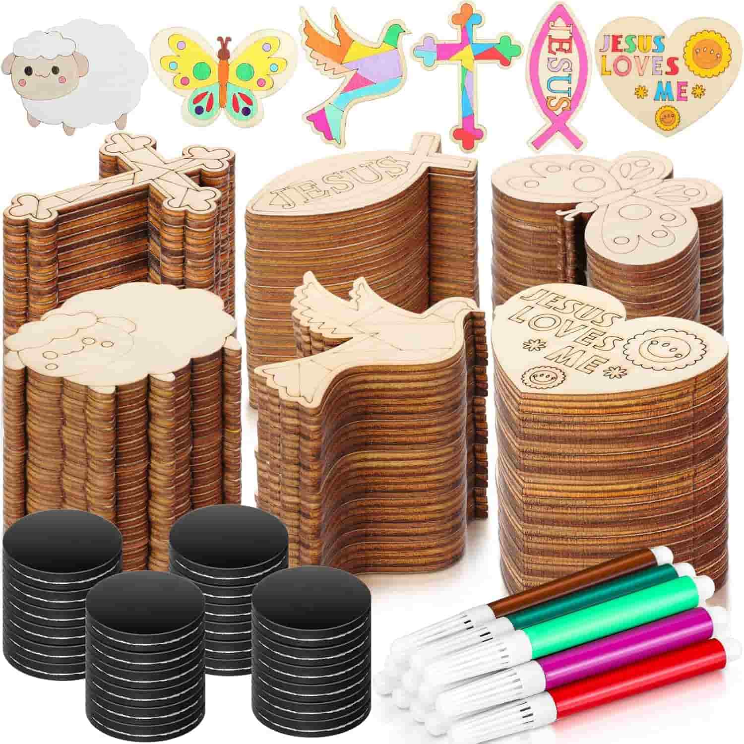 Stacks of wooden cutouts in various shapes, colored markers, and black paint pots arranged together, with examples of decorated cutouts shown at the top.