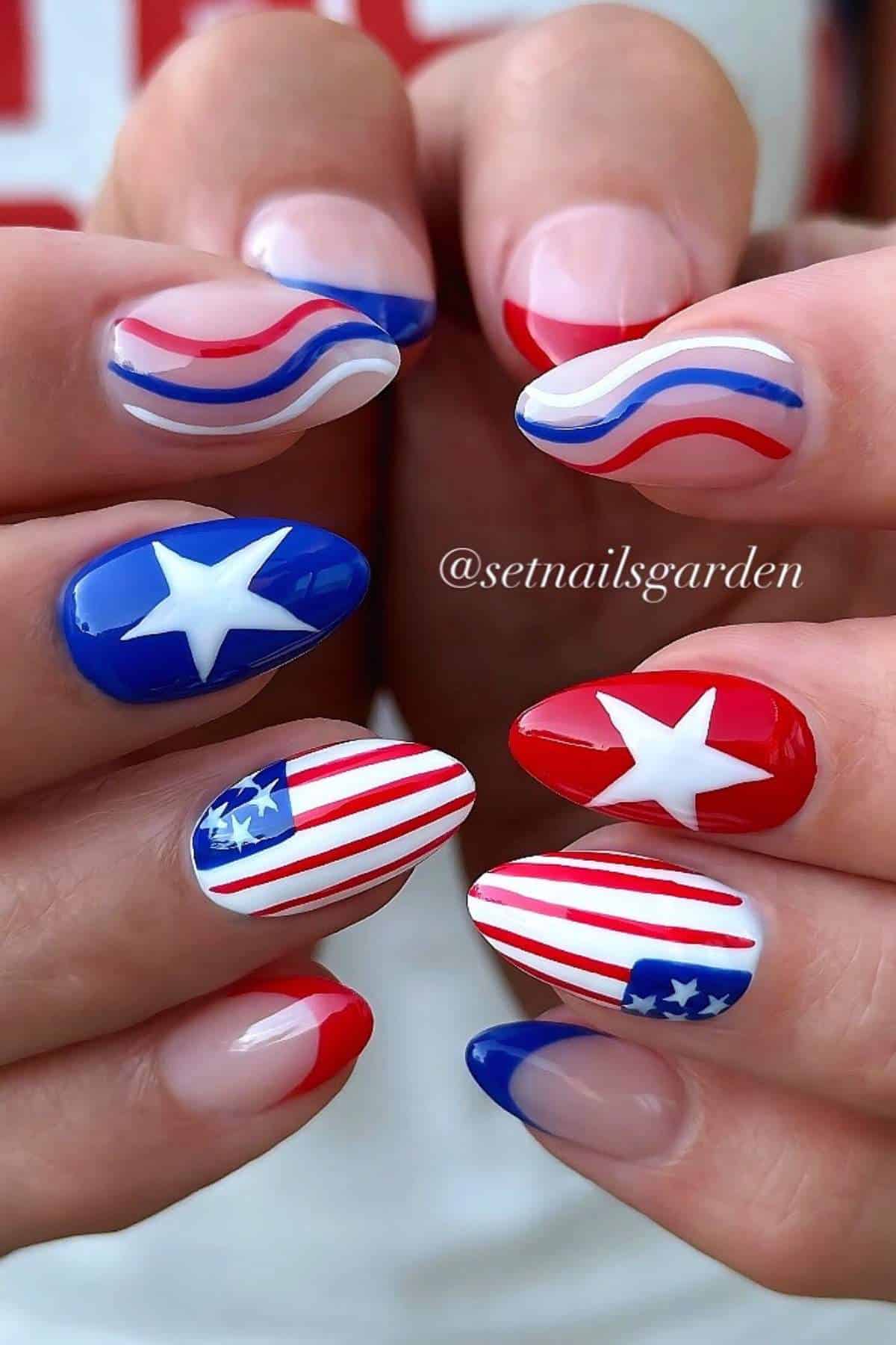 Close-up of hands with patriotic nail art featuring red, white, and blue stripes, stars, and flag designs on each fingernail.