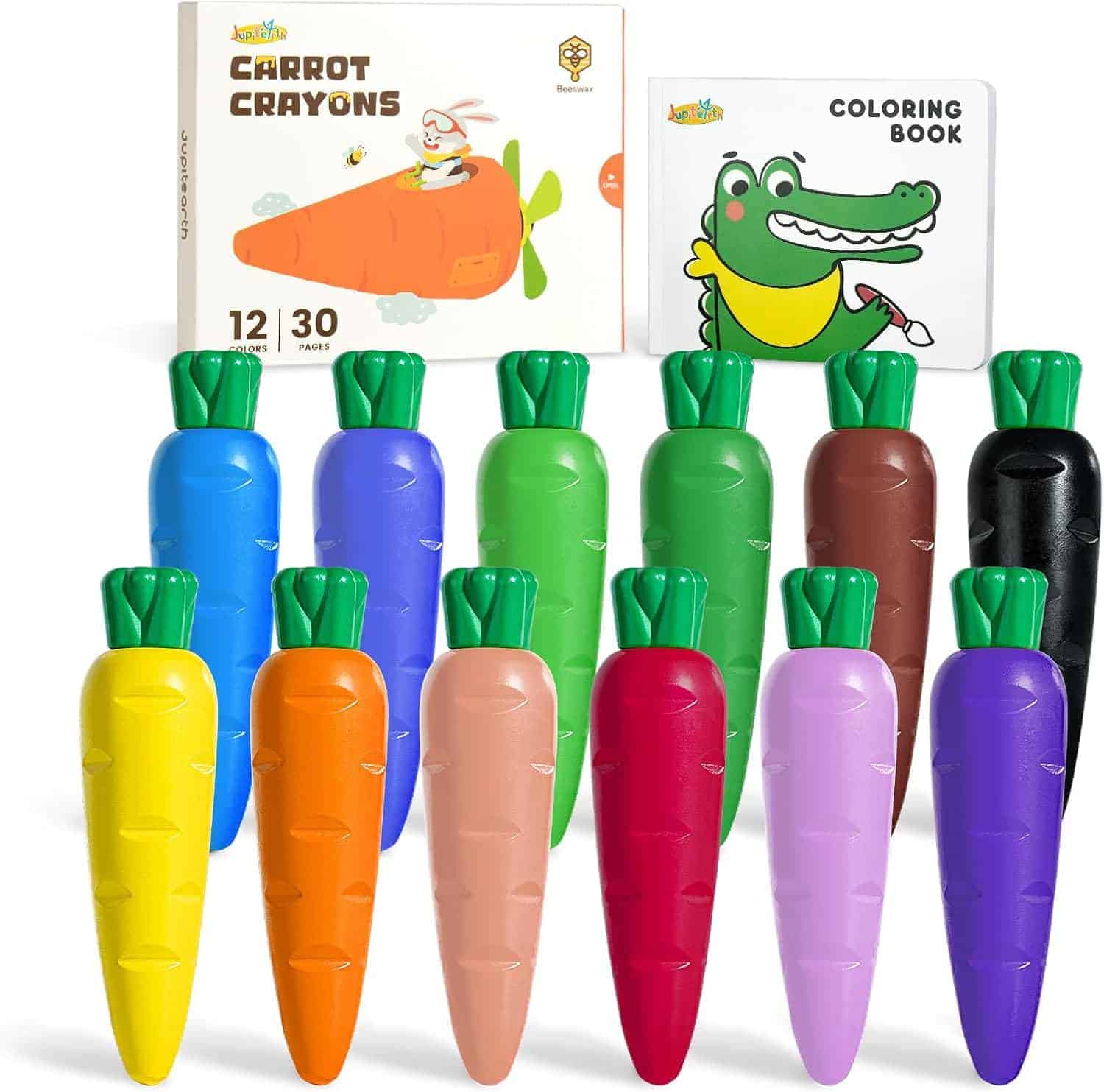 Twelve carrot-shaped crayons in various colors are displayed in front of a carrot-themed crayon box and a coloring book featuring a cartoon crocodile on the cover.