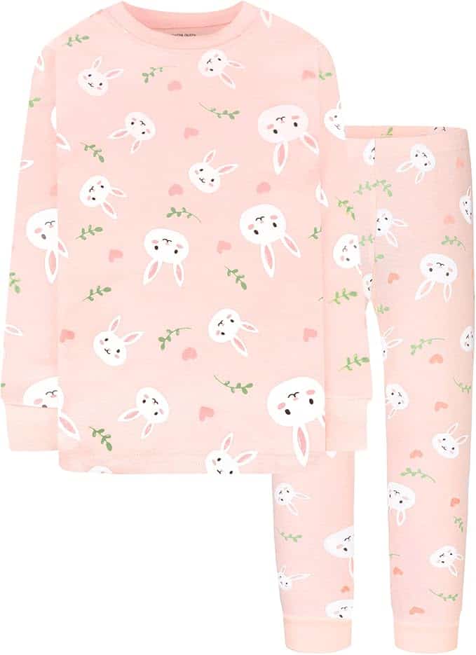 Pink children's pajama set with long sleeves and pants, featuring a pattern of white bunny faces, green leaves, and pink hearts.