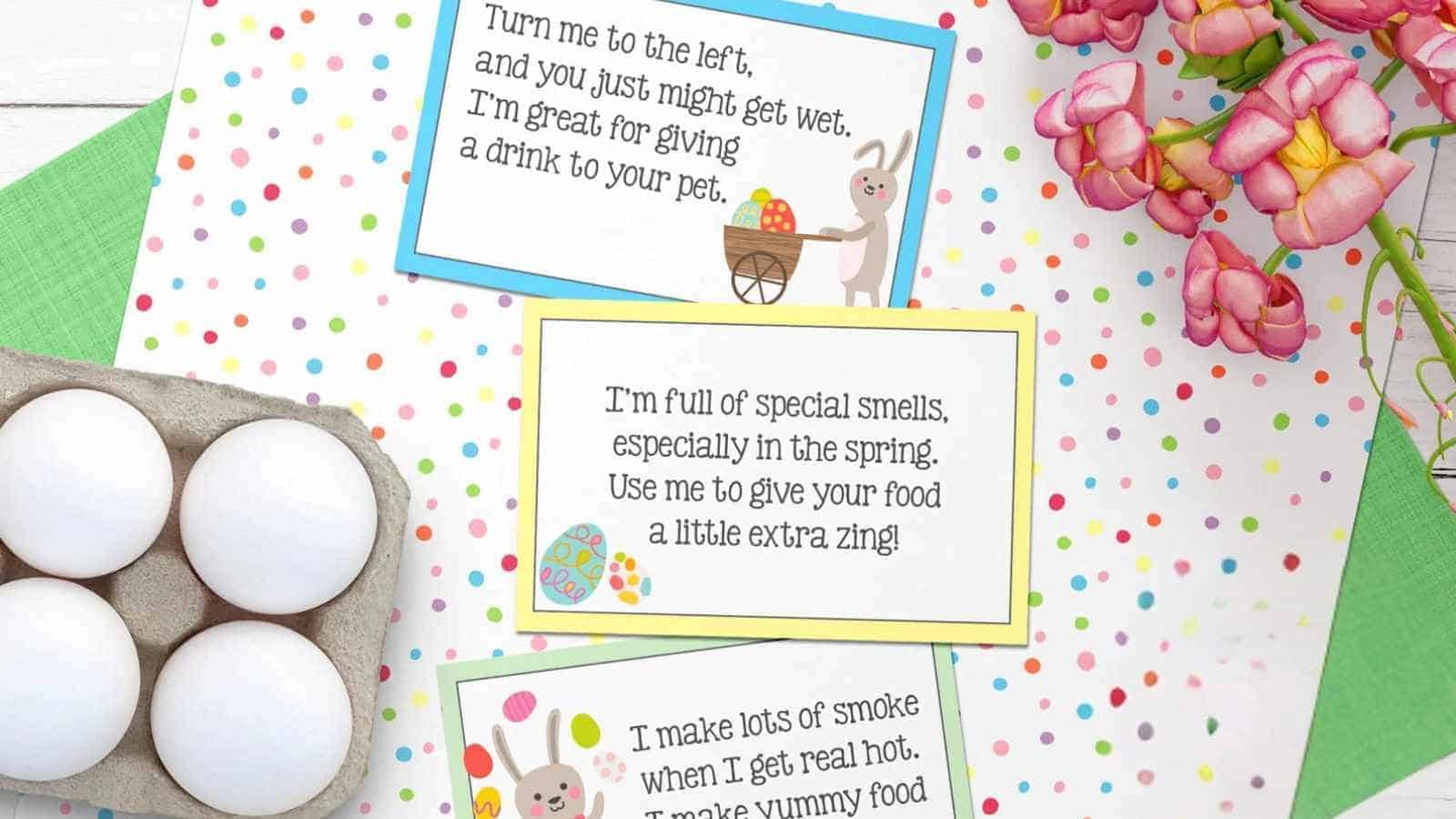 Three colorful cards with Easter-themed riddles are displayed on a polka dot surface next to a carton of white eggs and a bunch of pink flowers.