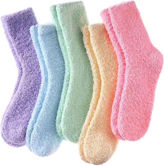 Five pairs of fuzzy socks in pastel colors: purple, blue, green, yellow, and pink, arranged side by side on a white background.