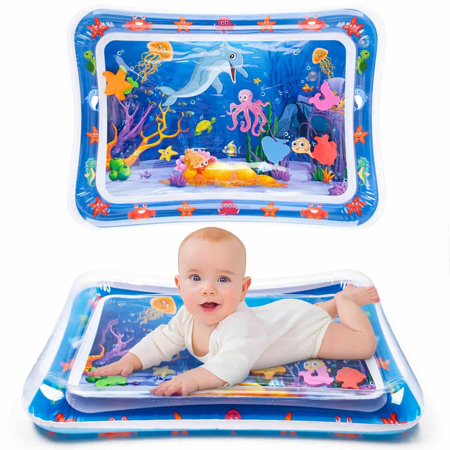 A baby lies on their stomach on an inflatable water play mat with colorful sea creature designs.