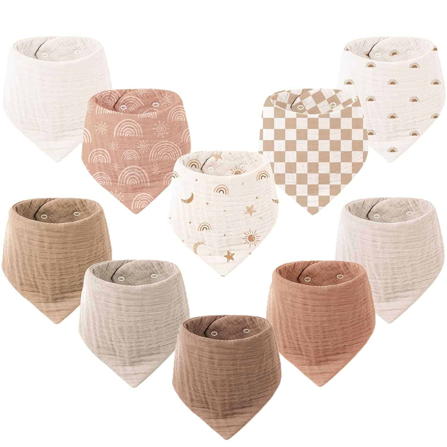 Ten baby bandana bibs in various neutral colors and patterns, including rainbows, stars, checkerboard, and solid shades, arranged in two rows.