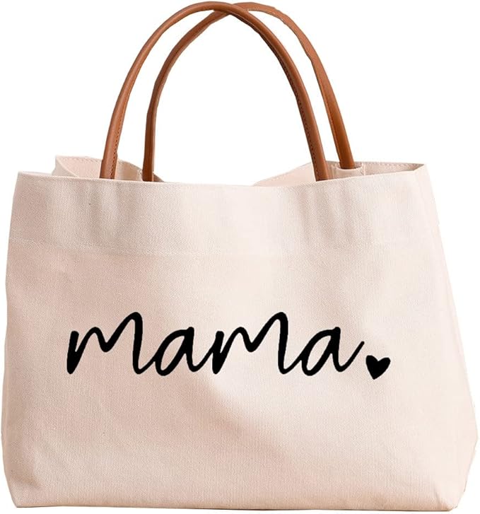 A beige canvas tote bag with brown handles and the word "mama" in black cursive lettering with a small heart on the front.