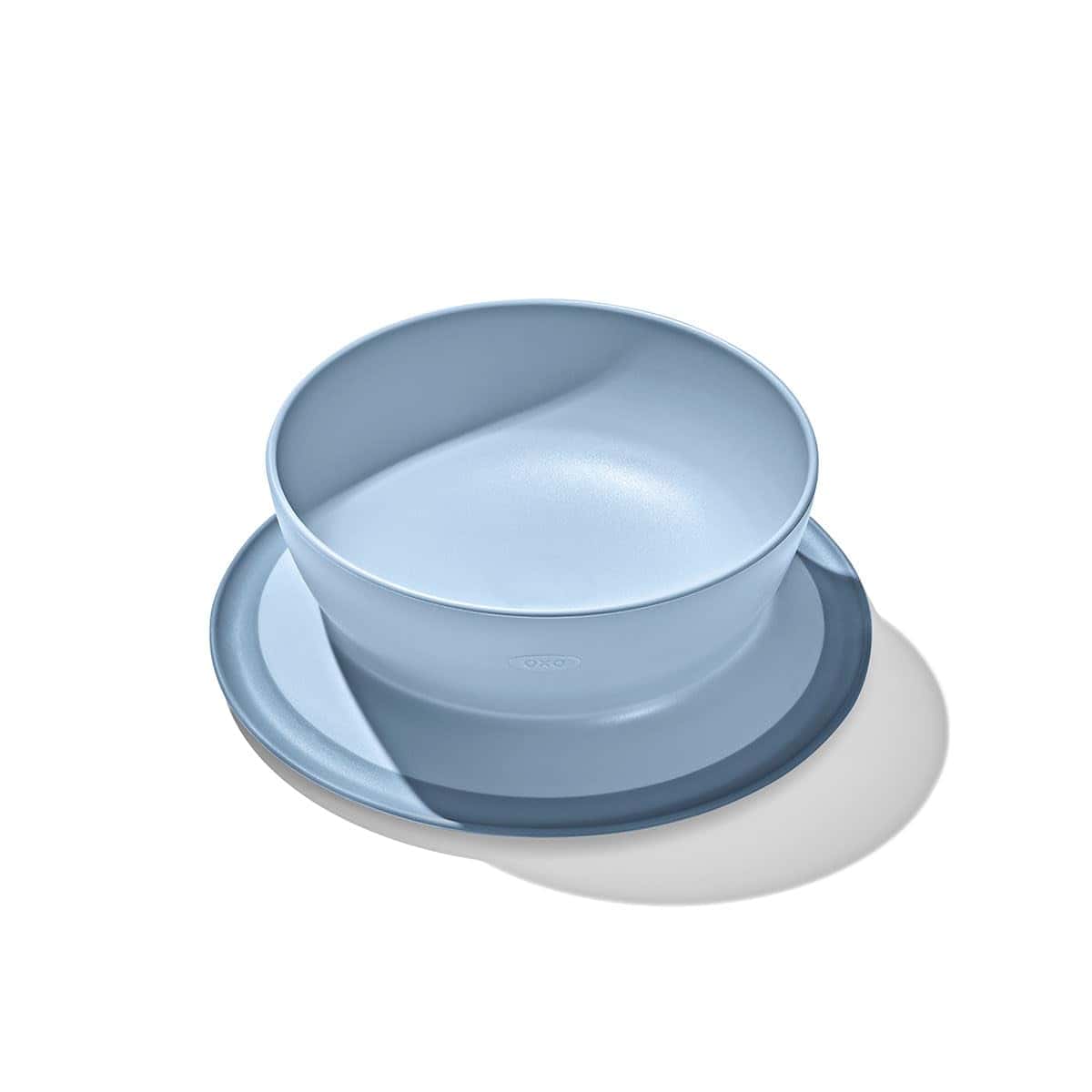 A light blue bowl placed on a matching round plate, photographed against a white background with visible shadow.