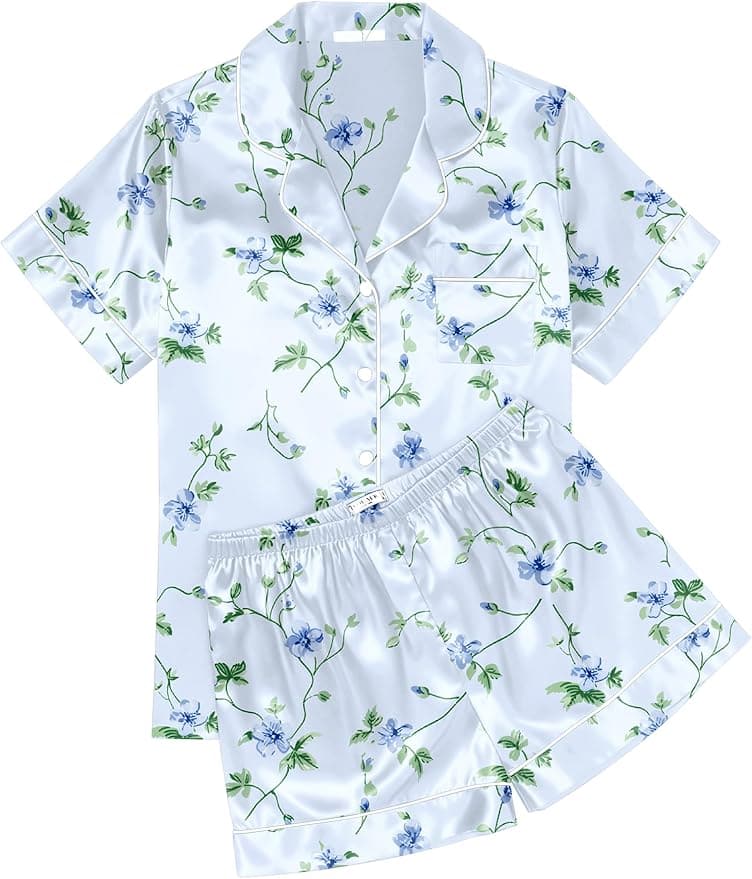 Two-piece satin pajama set with short sleeves and shorts, featuring a white base with blue and green floral print and white piping.