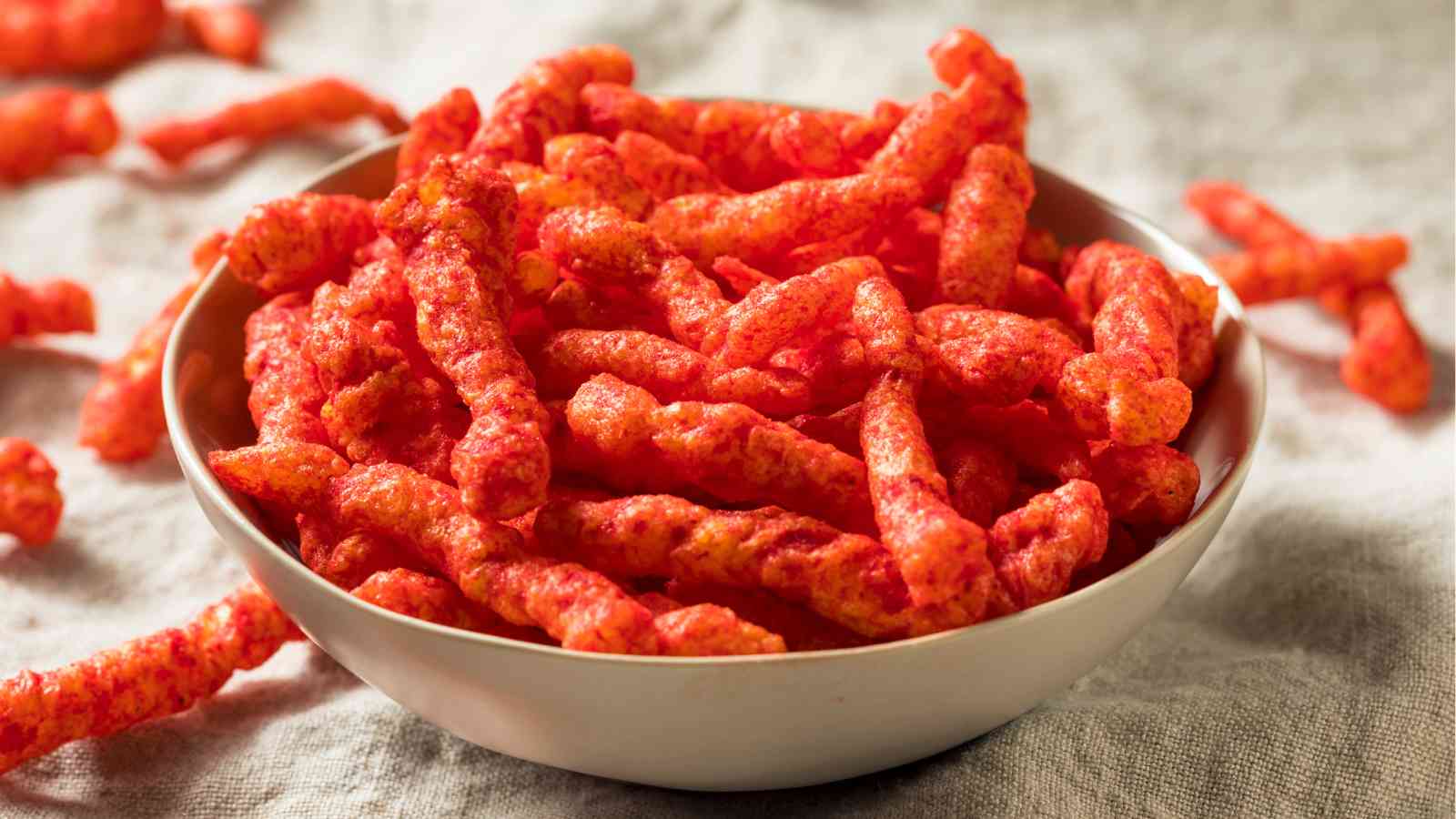 A bowl of cheesy snacks.