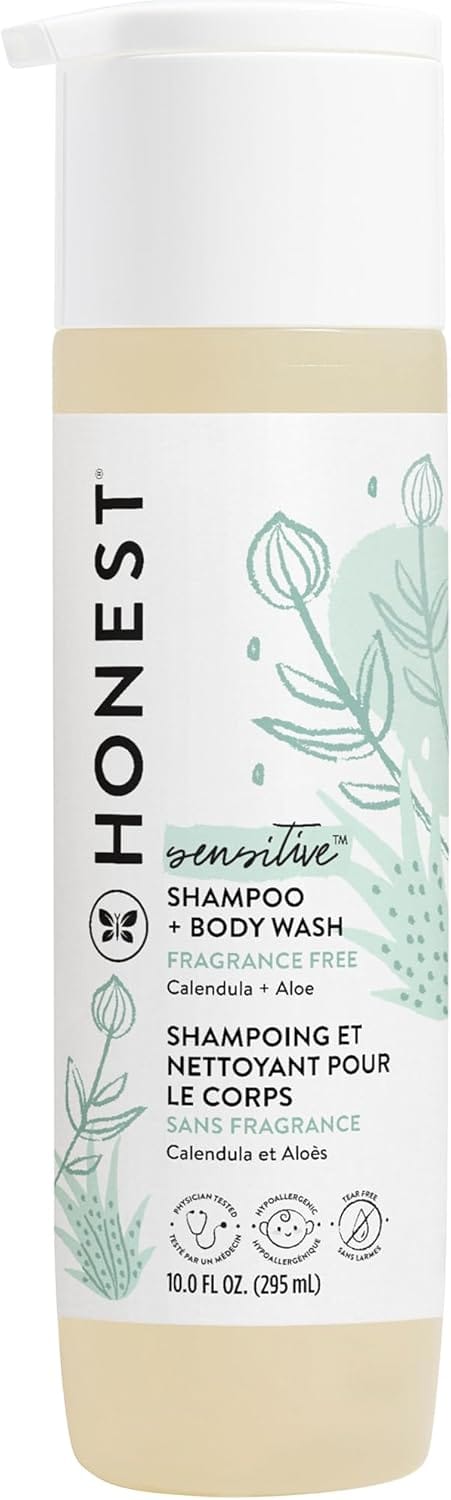 A bottle of Honest Sensitive Shampoo + Body Wash, fragrance free with calendula and aloe, 10 fl oz (295 mL), featuring a white pump top and botanical design on the label.