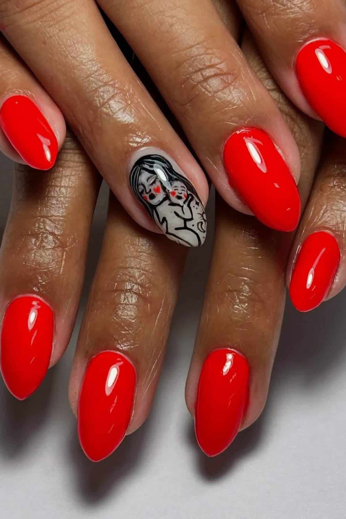 Hands with glossy red nail polish; one fingernail features black and white nail art depicting a woman's face with red accents.