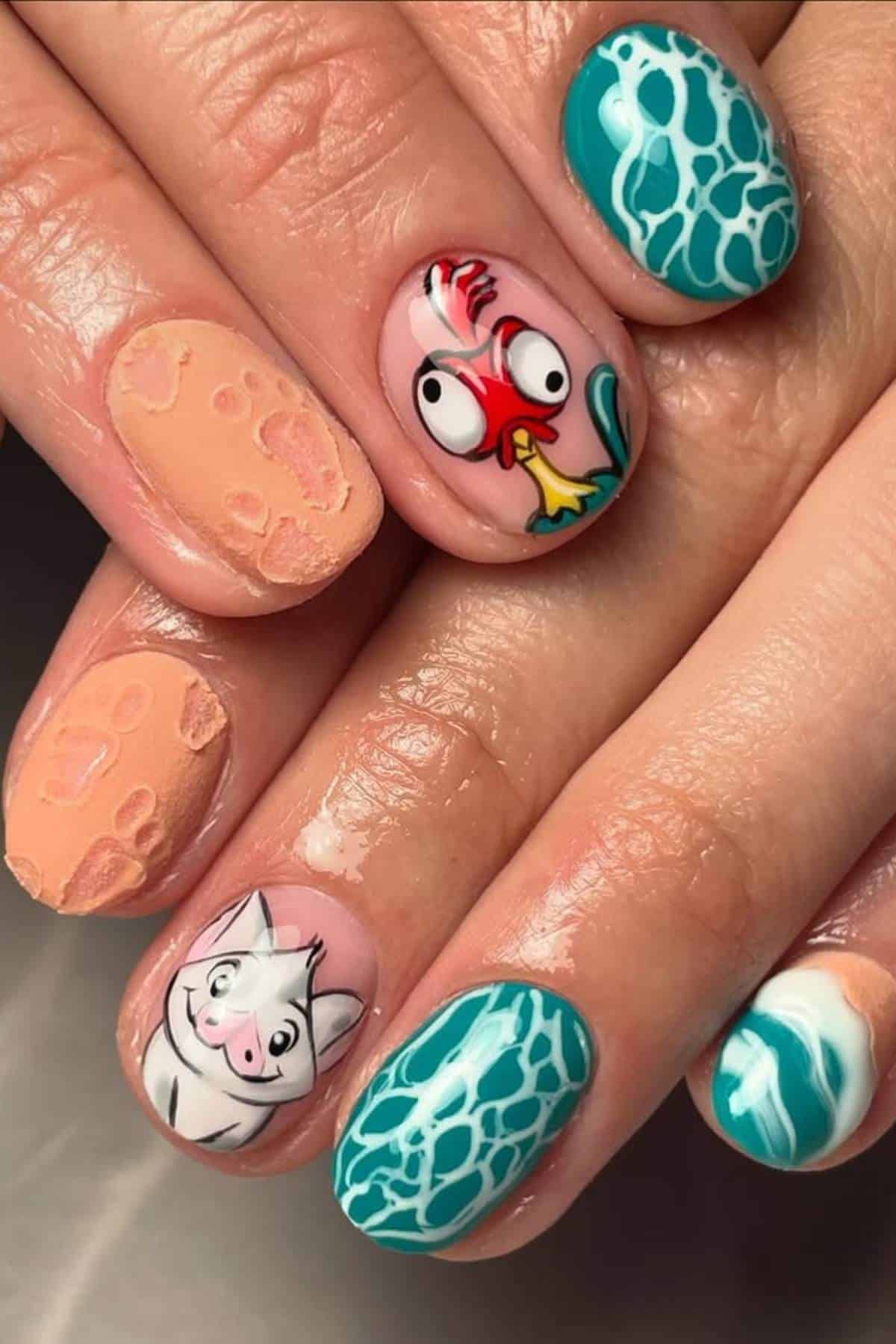 Close-up of hands with colorful nail art featuring cartoon animal faces, blue wave patterns, and textured peach designs.