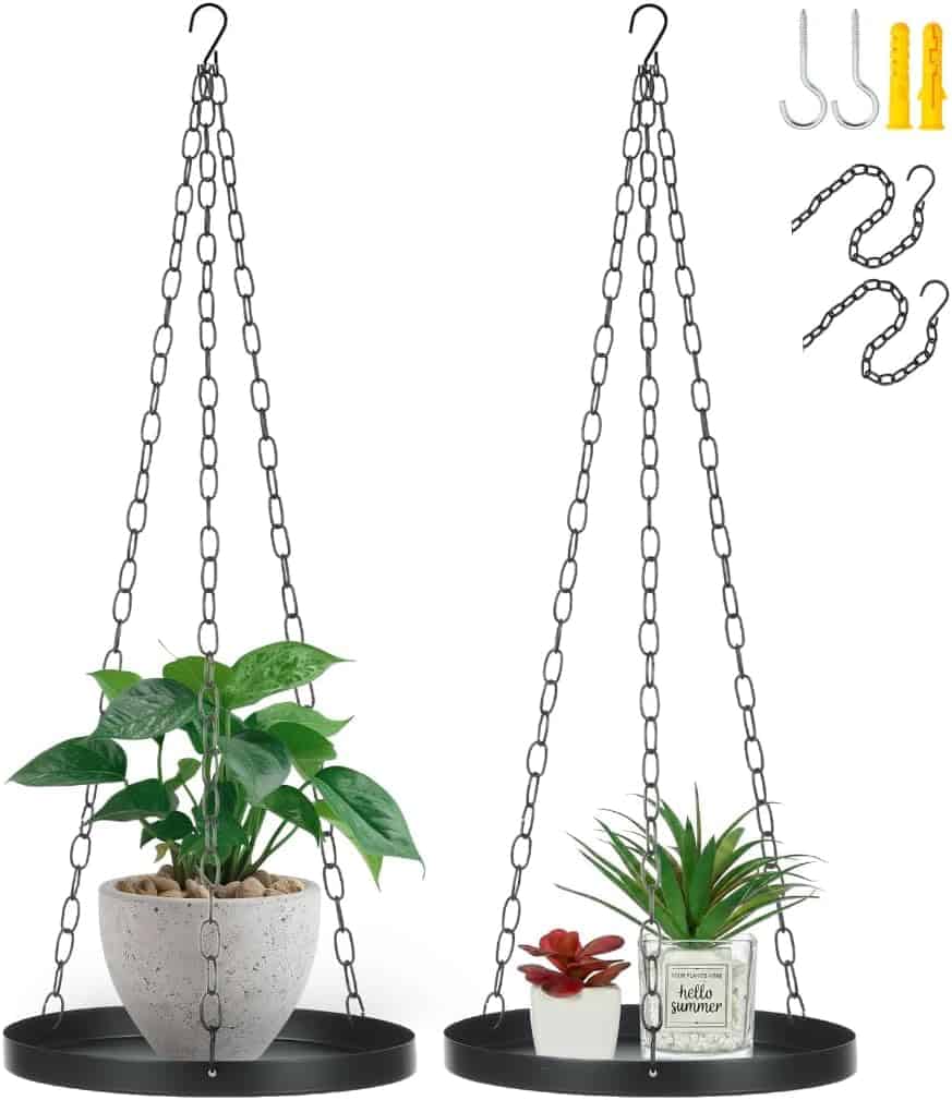 Two black hanging metal plant shelves with chains, each holding small potted plants; hooks and wall anchors are shown in the upper right corner.