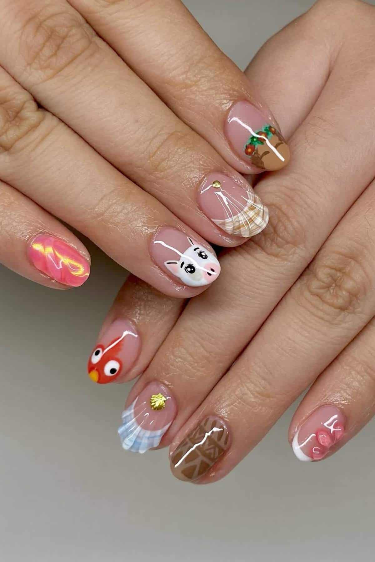 Hands with manicured nails, each featuring a unique design including a sheep, a bird, plaid, seashells, swirls, and other colorful patterns.