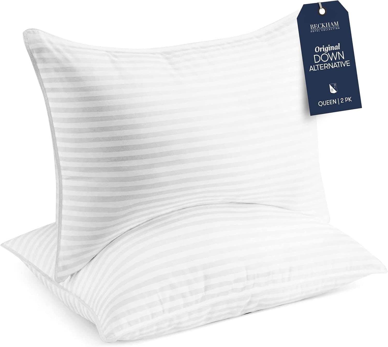 Two white, striped queen-size pillows are stacked with a tag reading "Original Down Alternative, Queen, 2 PK" attached to the top pillow.
