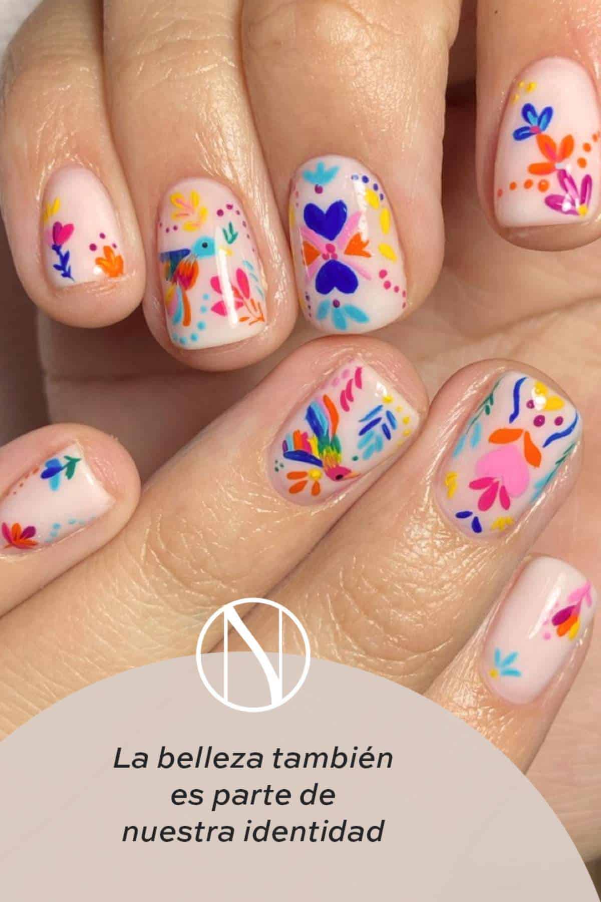 Close-up of hands with nails painted in colorful, floral and heart patterns. Text in Spanish reads, "La belleza también es parte de nuestra identidad.