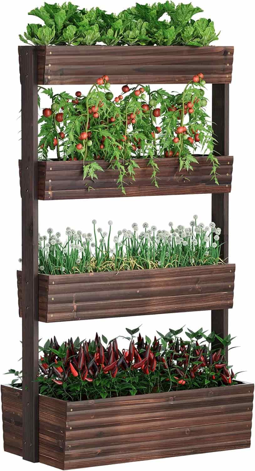 A vertical wooden planter holds four rows of vegetables, including leafy greens, tomatoes, onions, and peppers.