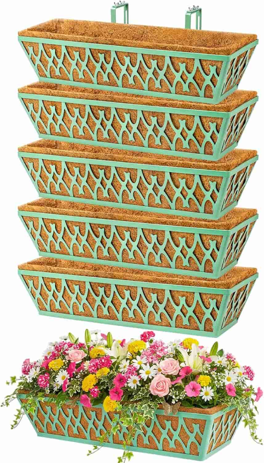 Six wall-mounted rectangular planters with decorative turquoise metal frames, five empty and stacked, one filled with assorted colorful flowers.