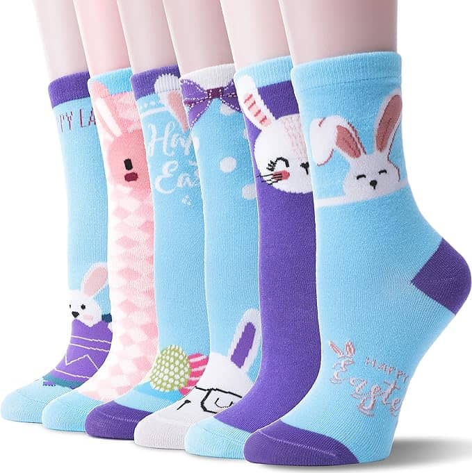 Six pairs of colorful crew socks with Easter and bunny designs displayed on mannequin legs.