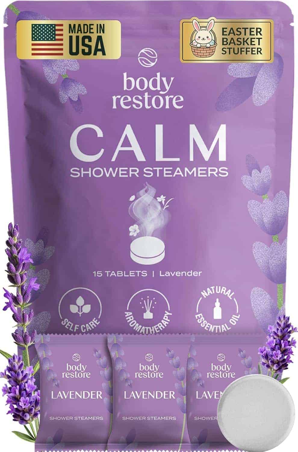 A package of Body Restore Calm Lavender Shower Steamers, featuring 15 tablets, self-care and aromatherapy icons, "Made in USA" and "Easter Basket Stuffer" labels, with lavender flowers.