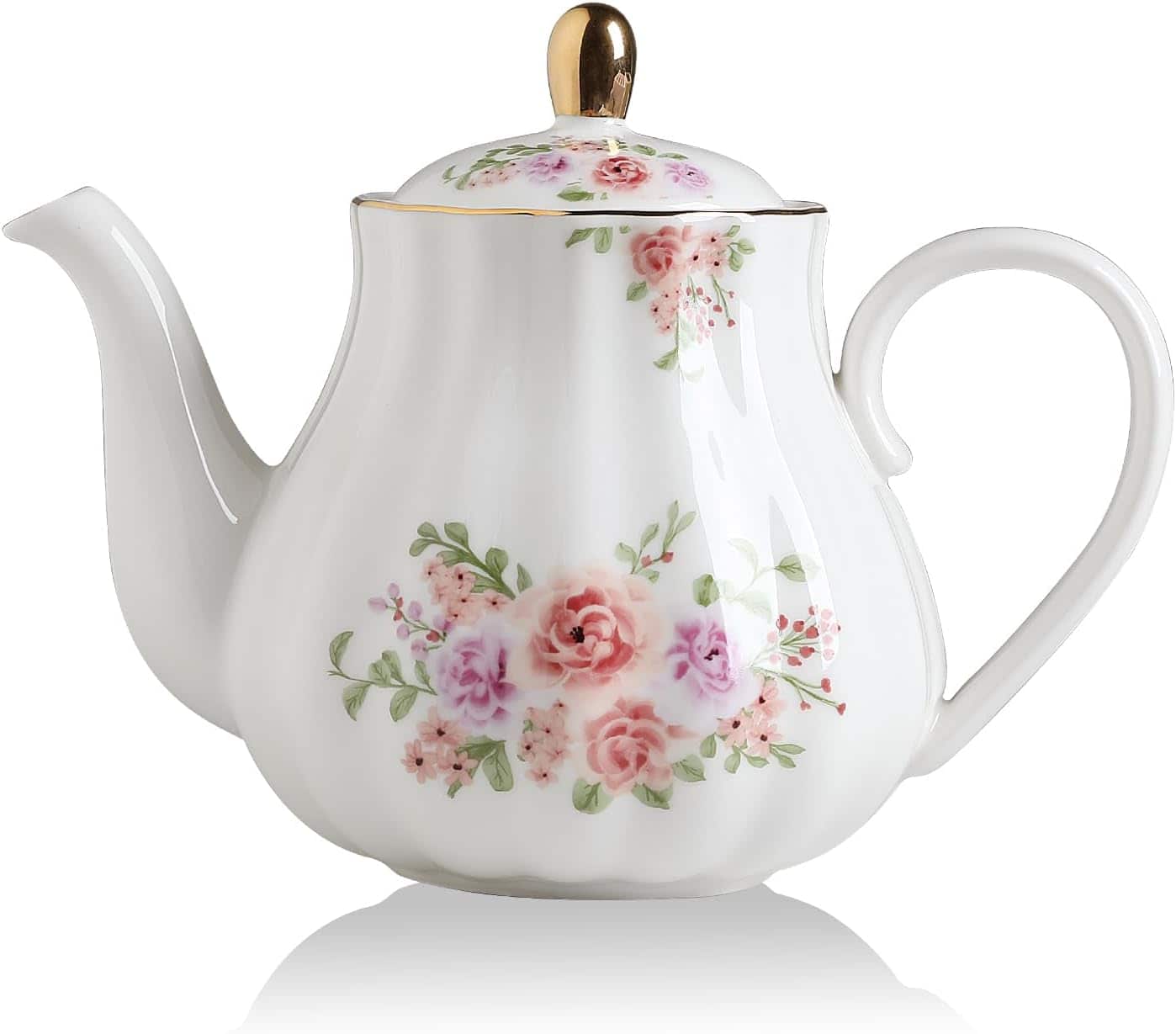 White porcelain teapot with a curved handle, floral pink and green design, gold-tipped lid and spout, set against a plain background.