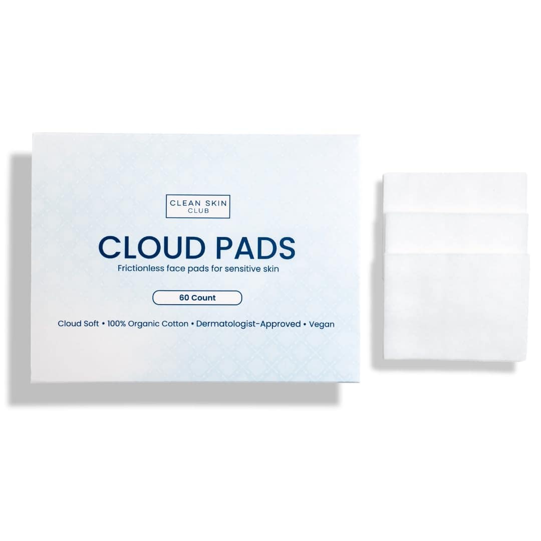 A box labeled "Cloud Pads" by Clean Skin Club is shown next to three white rectangular face pads. The box indicates 60 count, 100% organic cotton, dermatologist-approved, and vegan.