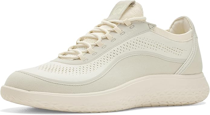 A beige athletic shoe with a textured sole, perforated details on the upper, and matching laces.