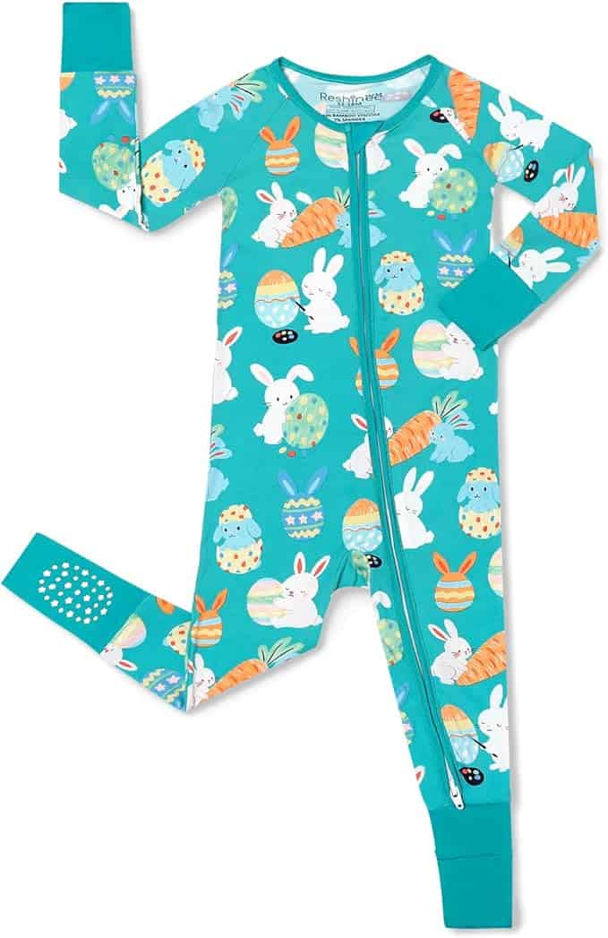 A teal-colored children's onesie featuring a pattern of Easter eggs, bunnies, and carrots, with a front zipper and long sleeves.