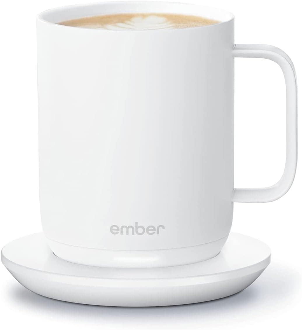 A white Ember mug filled with coffee sits on a matching white saucer against a plain background.