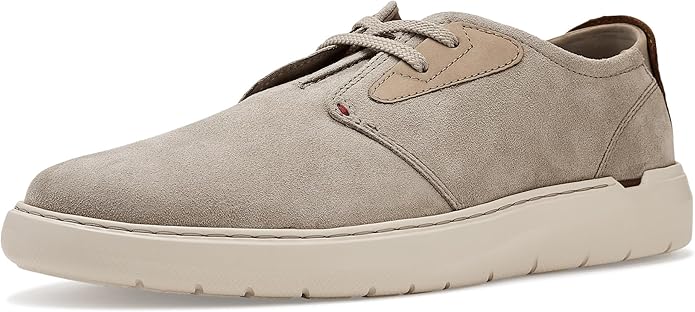 A beige suede casual shoe with a white rubber sole, lace-up closure, and a subtle tan accent near the laces.