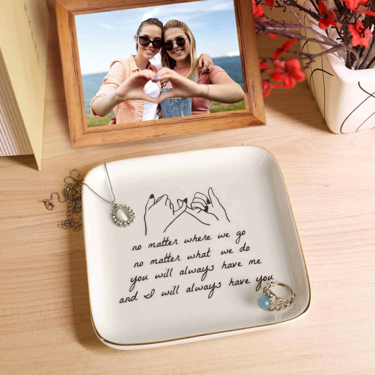 A jewelry dish with a pinky promise illustration and the text "no matter where we go, no matter what we do, you will always have me and I will always have you," holding a necklace and ring.