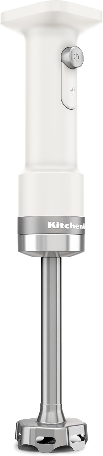 A white KitchenAid immersion hand blender with a power button and stainless steel blending arm, shown upright against a plain background.