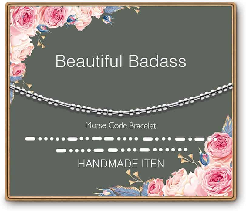 A "Beautiful Badass" Morse code bracelet is displayed on a floral card with beads and the words "Handmade Item.