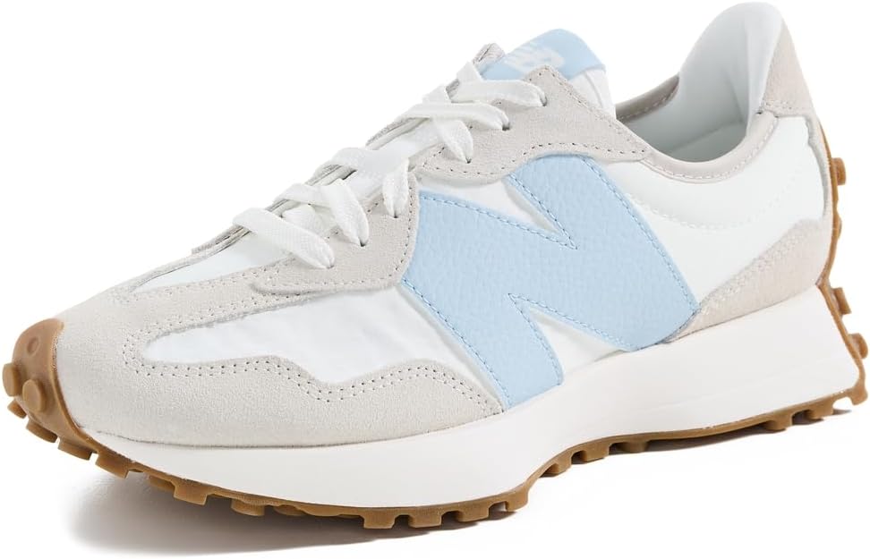 A white sneaker with light blue and beige accents, white laces, and a tan rubber sole displayed on a white background.