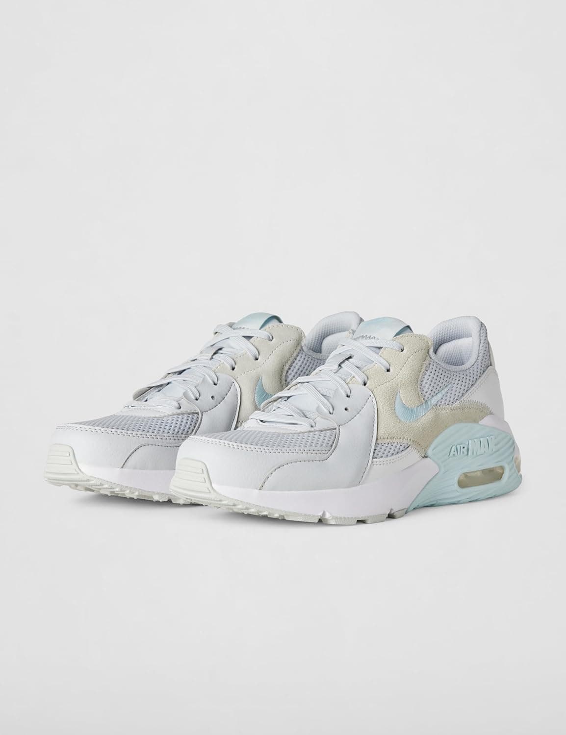 A pair of Nike Air Max sneakers in white, light gray, and pale blue, displayed on a plain light background.