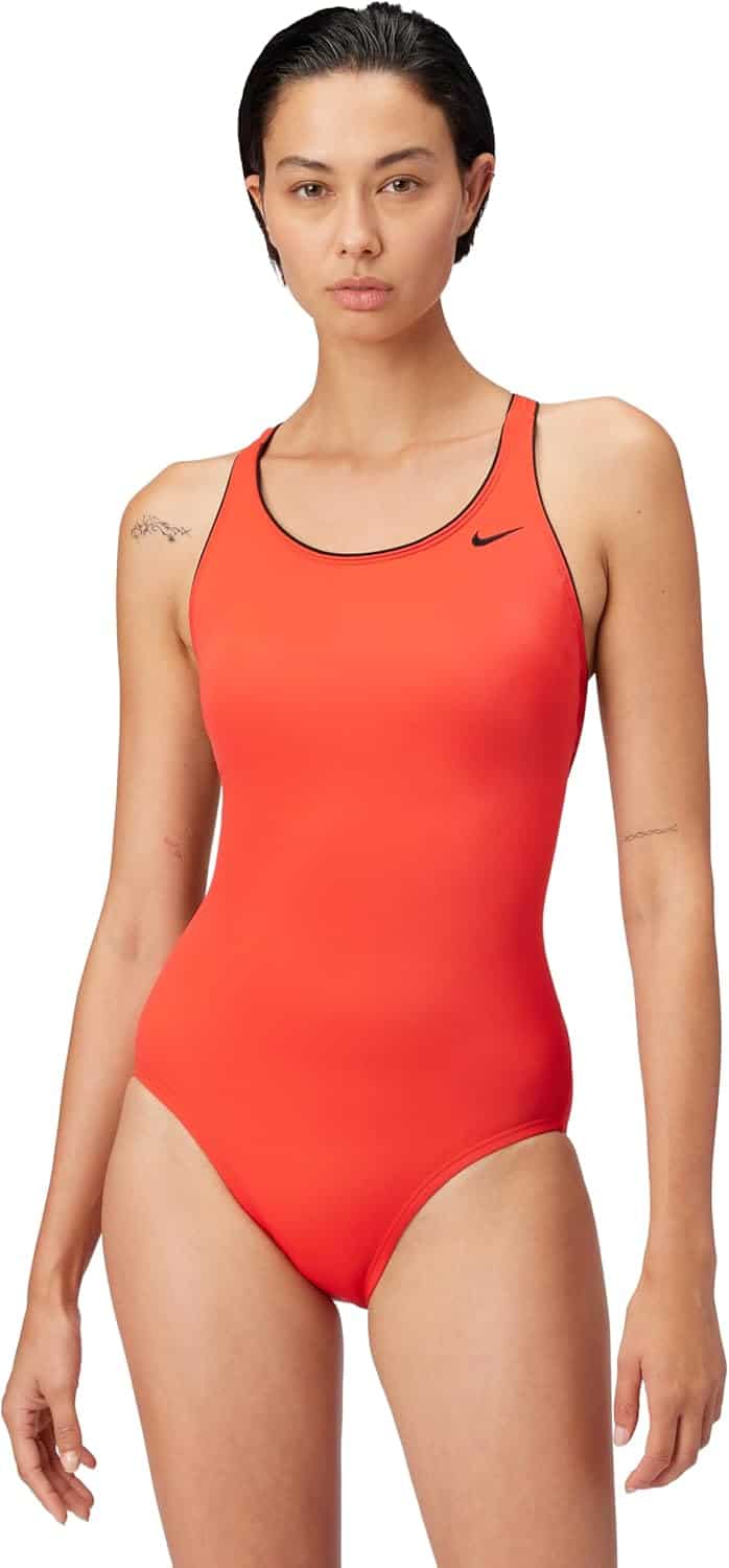 A person stands facing forward wearing a bright orange one-piece swimsuit with a black Nike logo on the left chest.