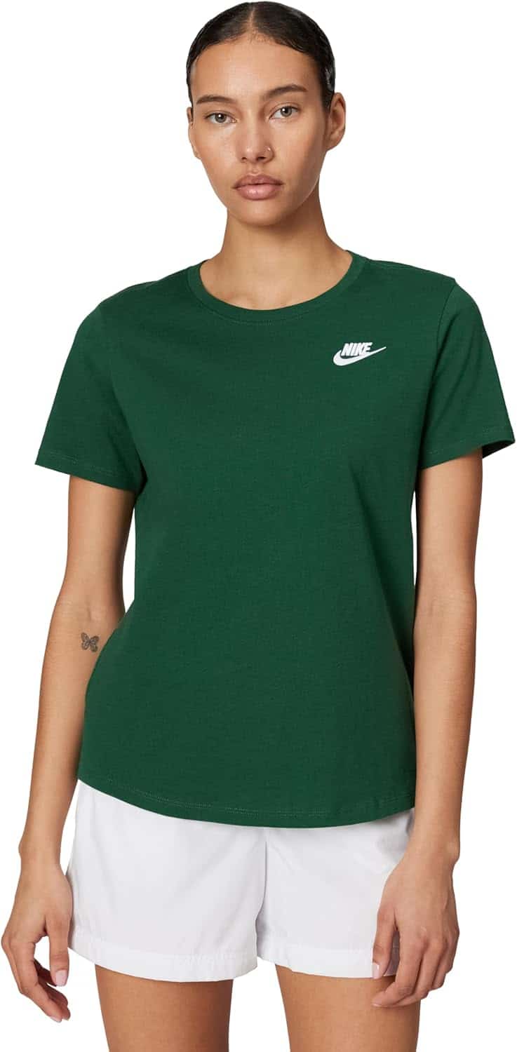 A person wearing a dark green Nike t-shirt and white shorts stands facing forward with a neutral expression.