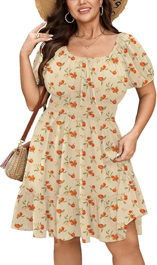 Woman wearing a light beige, short-sleeve, knee-length dress with an orange fruit print, carrying a straw bag, and wearing a straw hat.