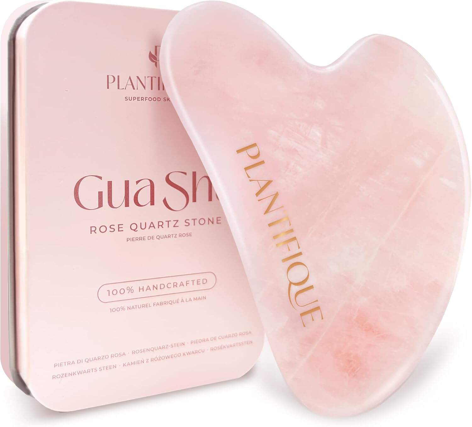 A rose quartz Gua Sha tool and its rectangular metal storage case, both labeled "Plantifique," are shown against a white background.