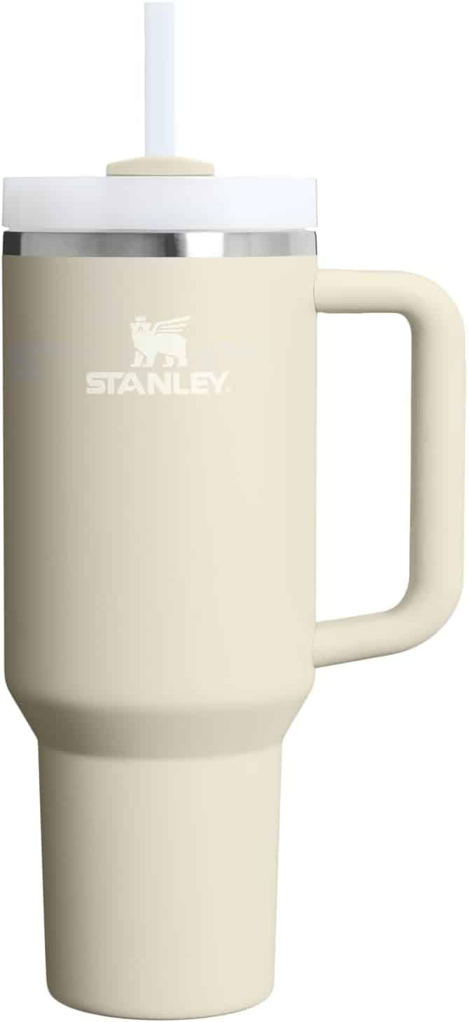 A beige Stanley travel tumbler with a handle, lid, and straw, shown against a white background.