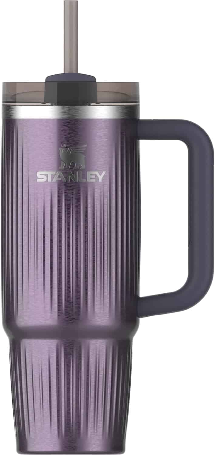 Tall, purple Stanley travel tumbler with a handle, textured vertical lines, clear lid, and a straw.