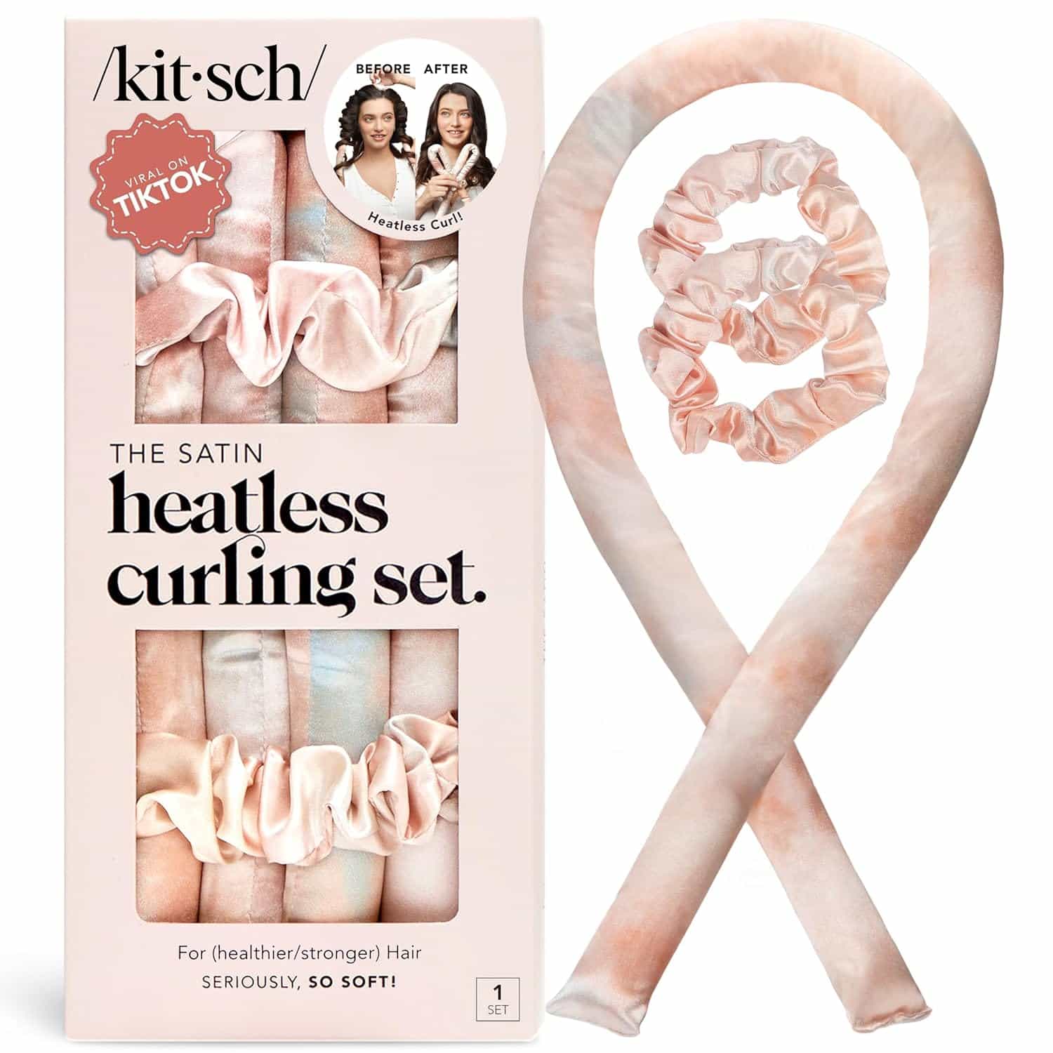 A Kitsch Satin Heatless Curling Set in soft pink tones, including a curling rod and two matching scrunchies, shown next to its product packaging.