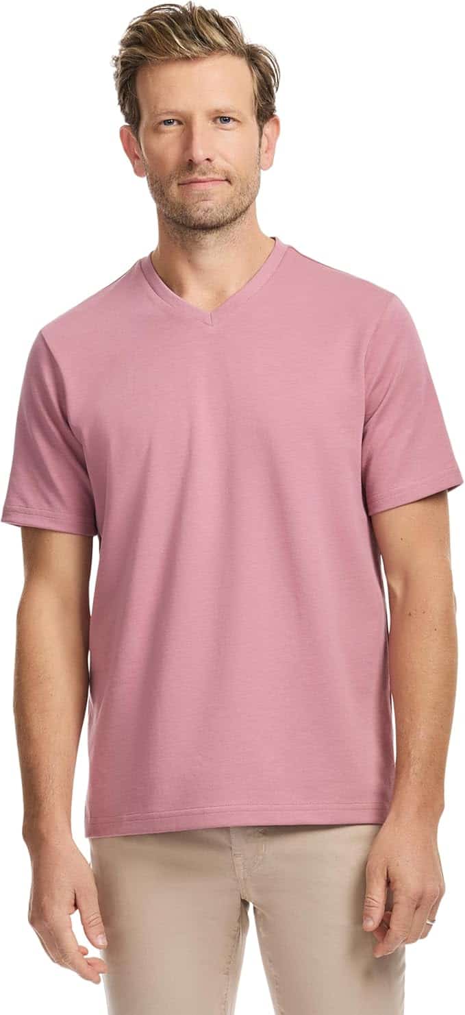 Man wearing a light pink short-sleeve V-neck T-shirt and beige pants, standing against a plain white background.