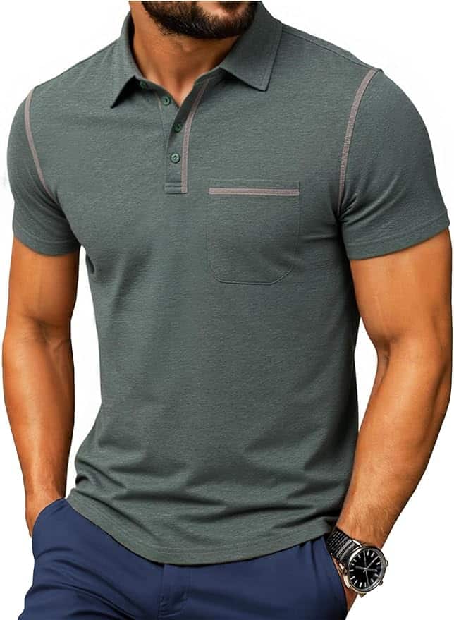 Man wearing a short-sleeve, gray-green polo shirt with a chest pocket and dark trim, paired with navy pants and a black wristwatch.