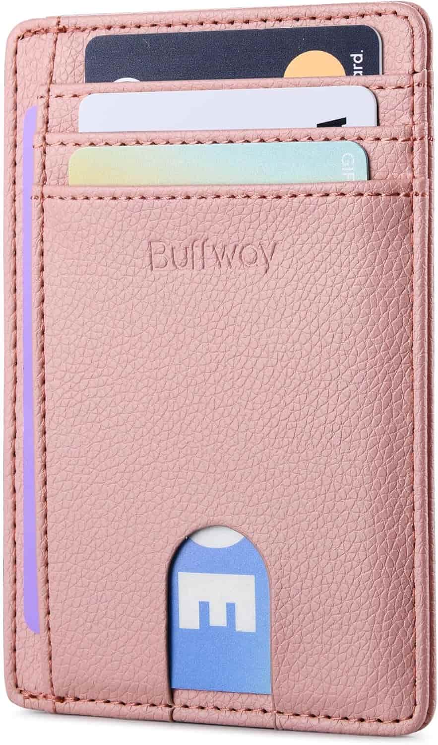 A pink leather Buffway wallet with several cards visible in its slots, including a gift card and an ID card.
