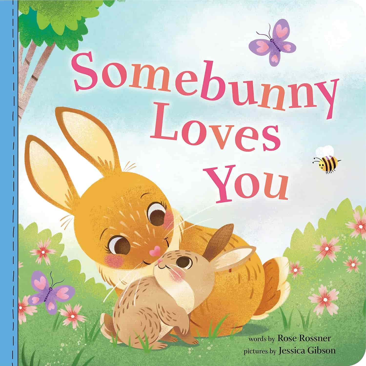 Illustrated cover of the children's book "Somebunny Loves You" showing two rabbits nuzzling in a grassy field with flowers, a butterfly, and a bee.