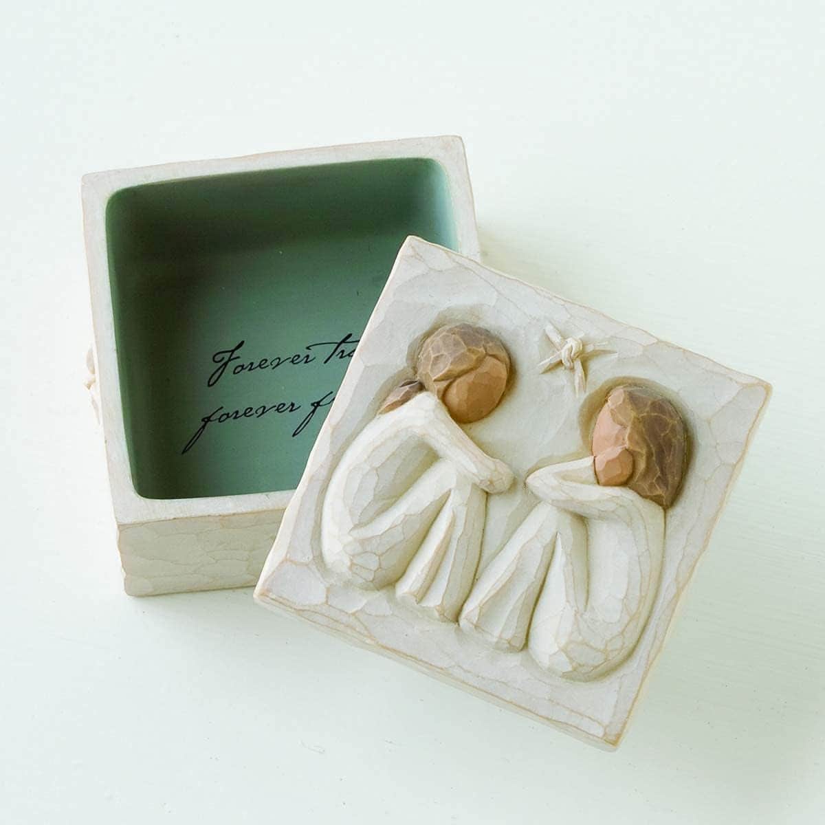 Square trinket box with a lid featuring two carved figures sitting together and a small star; inside, the words "Forever true, forever friends" are inscribed.