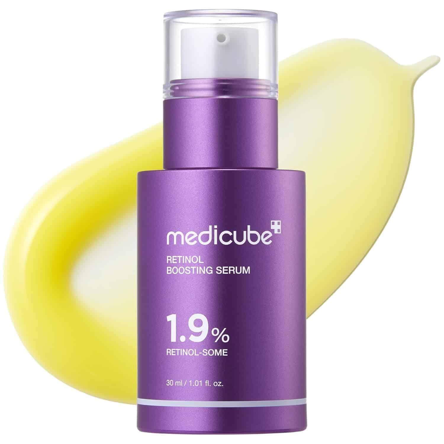 A purple bottle of Medicube Retinol Boosting Serum, 1.9% retinol-some, 30 ml, shown with a yellow cream smear in the background.