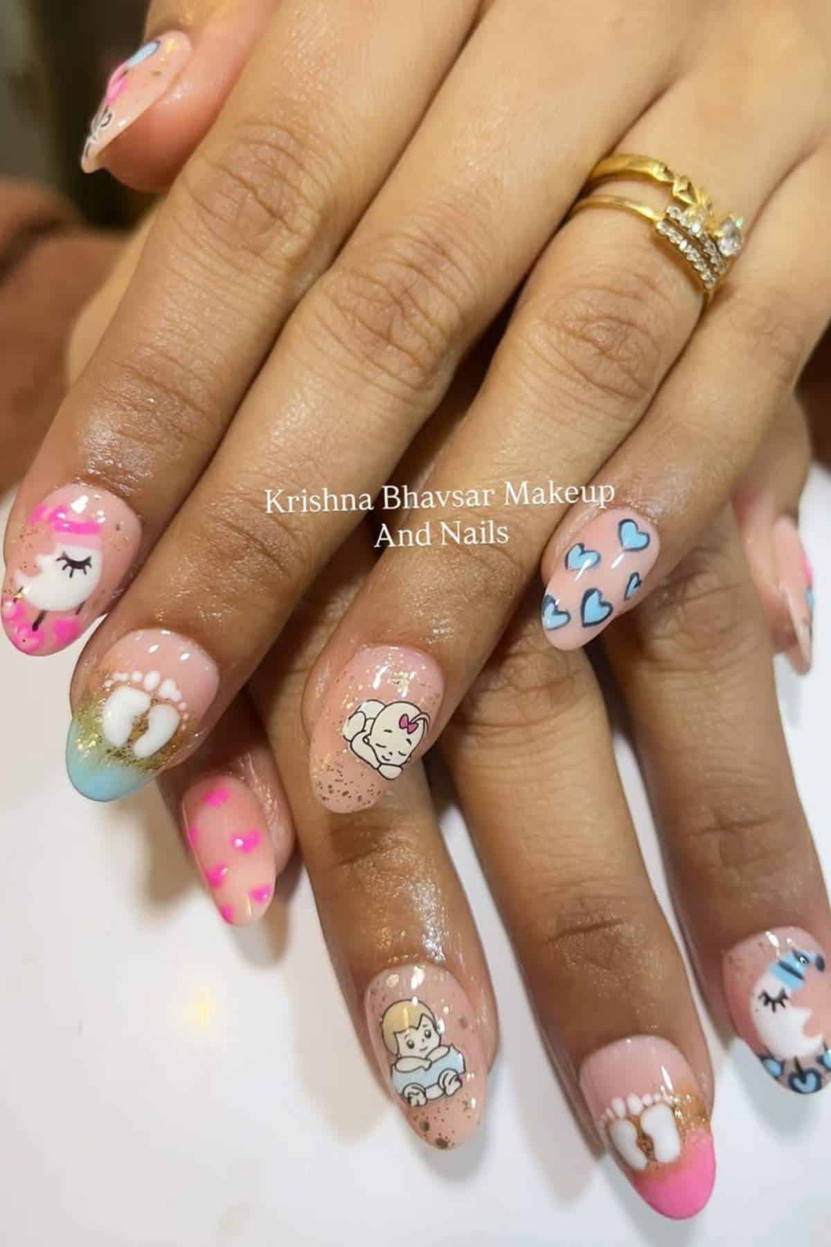 Hands with long nails featuring detailed nail art, including cartoon animal faces, hearts, and colorful tips in pink, blue, and gold accents. Two rings are worn on one finger.