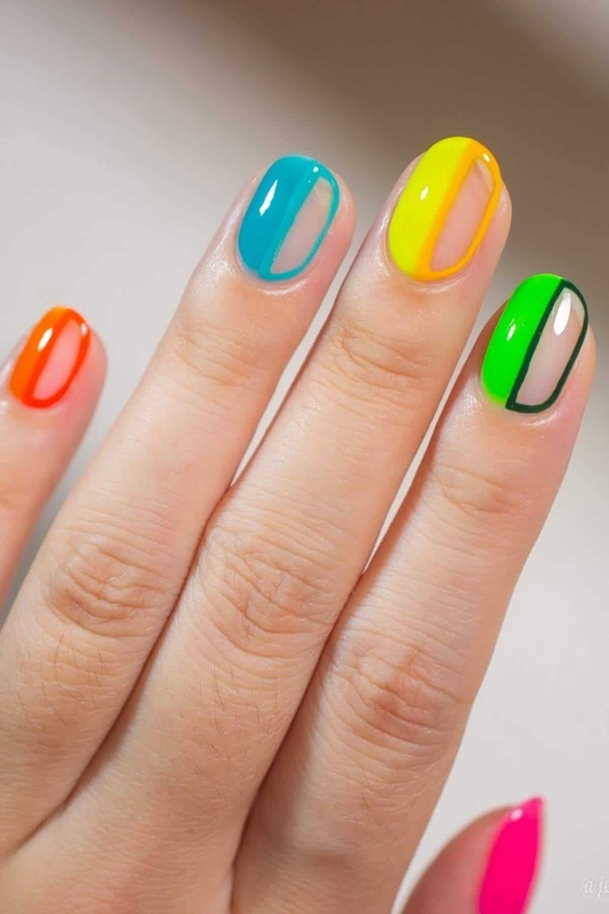 A hand with brightly painted nails, each featuring a different neon color and a vertical transparent stripe design.